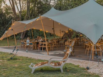 Restaurant installed under a tent in a pear orchard in Avignon