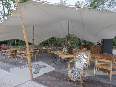 Restaurant installed under a tent in a pear orchard in Avignon