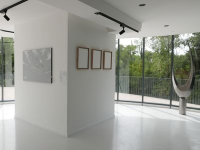 Gallery with terrace and view of greenery