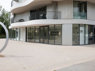 Gallery with terrace and view of greenery