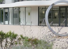 Gallery with terrace and view of greenery