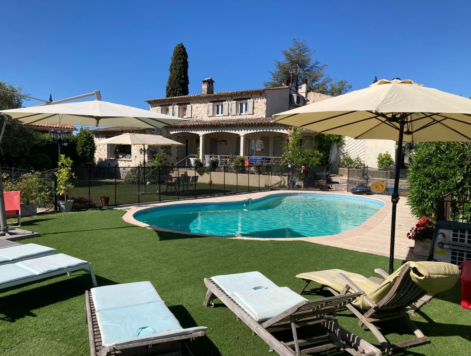 Garden with swimming pool and view of St Paul and the hills of Vence