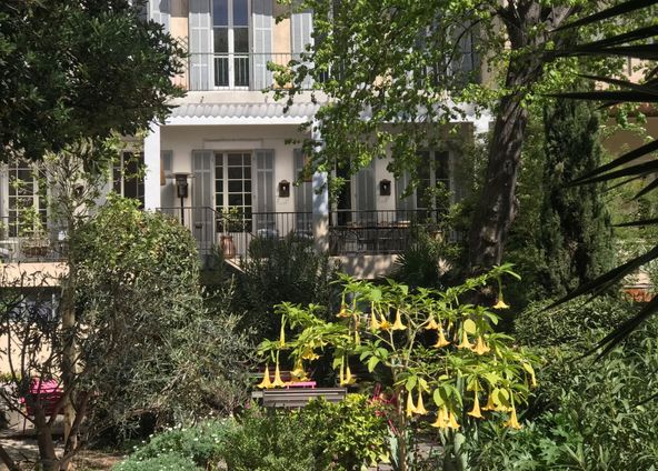 Covered terrace and outdoor terrace in a large garden in the city center