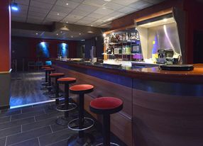 Jazz club with large bar and equipped stage