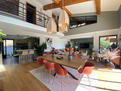 Outdoor space and a large living room with high ceilings and hill view