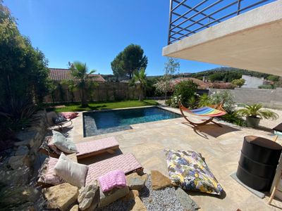 Outdoor space and a large living room with high ceilings and hill view