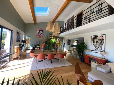 Outdoor space and a large living room with high ceilings and hill view