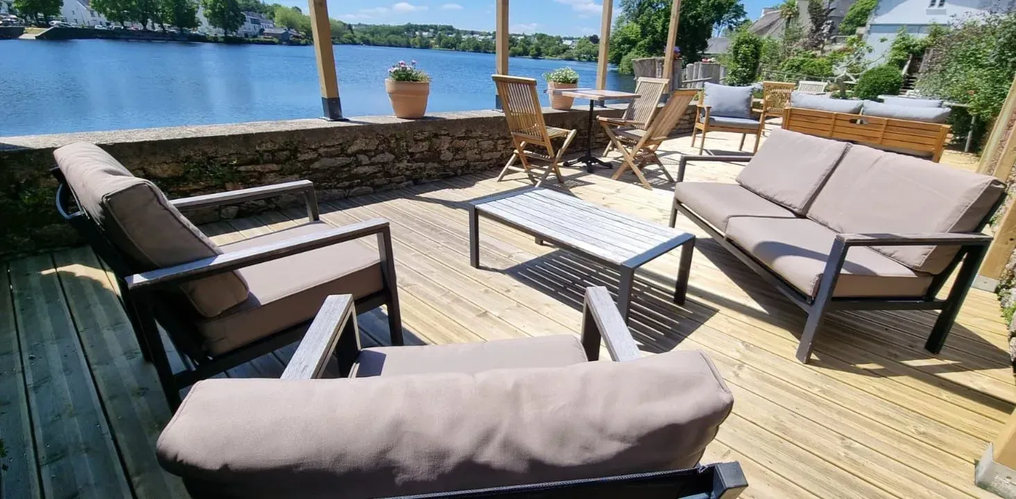 Beautiful lakeside garden with large wooden terrace overlooking the water