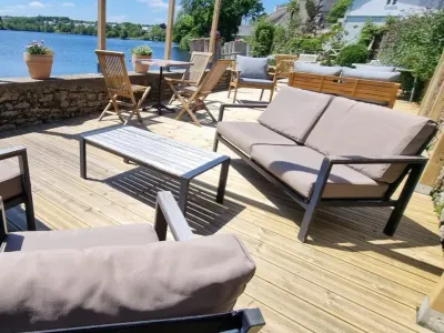 Beautiful lakeside garden with large wooden terrace overlooking the water