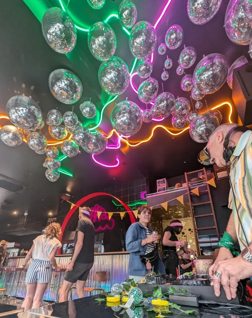 Glam Rock 80s Party Venue with Mirror Ball Ceiling & Neon Lights