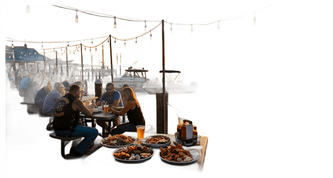 Golden sunset over a small Virginia waterfront pier with casual outdoor dining, seafood platters on tables, string lights overhead, boats bobbing in background. Relaxed bikers enjoying post-ride drinks, Potomac River glowing orange-gold in sunset light. Photography style: warm, cinematic, golden hour. Matching dark-background festival infographic color palette with deep blue water, golden amber sunset reflections, and chrome highlights.